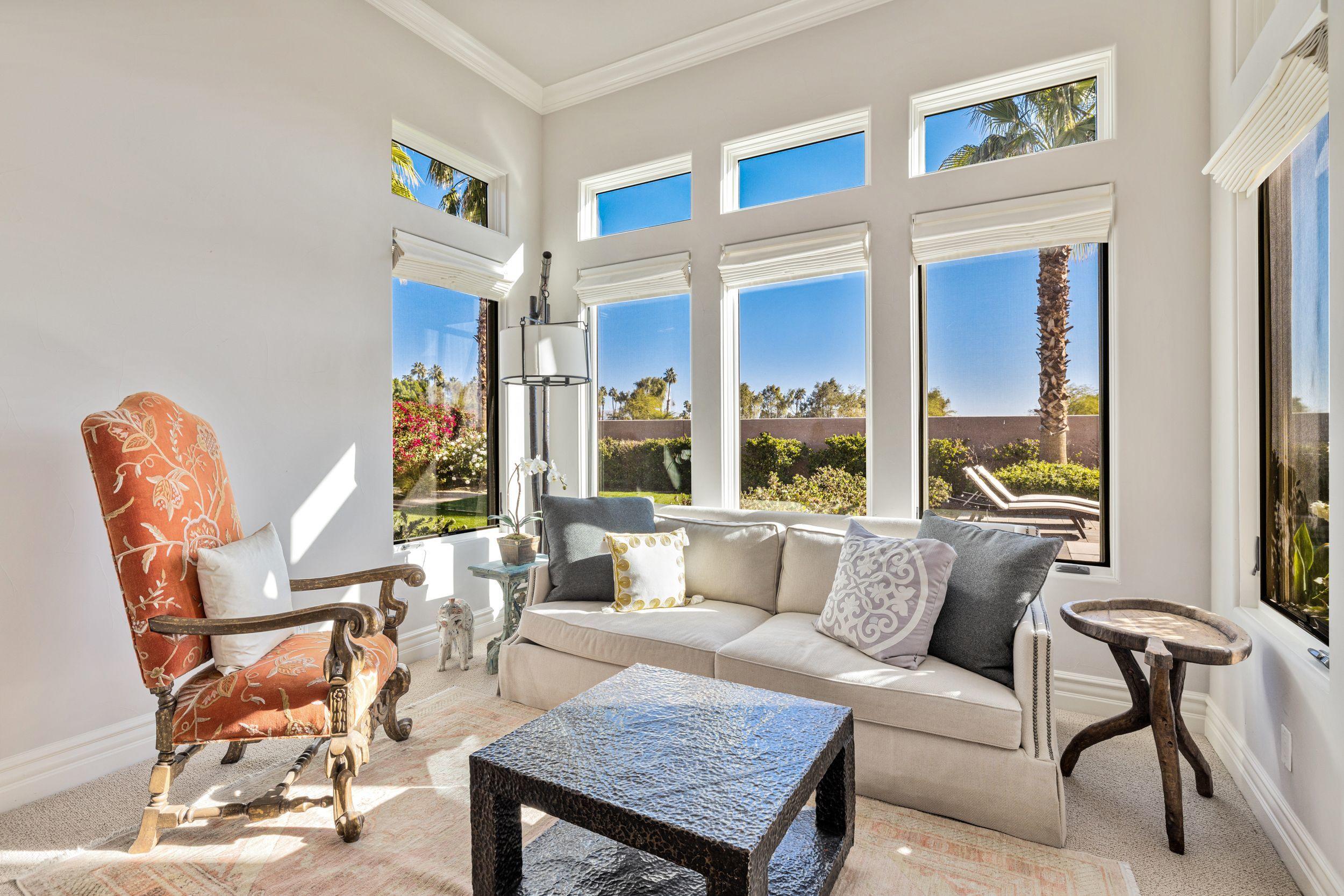 54360 Alysheba Drive La Quinta, CA 92253 - Photo 14 of 24 a living room with furniture a large window and a fireplace