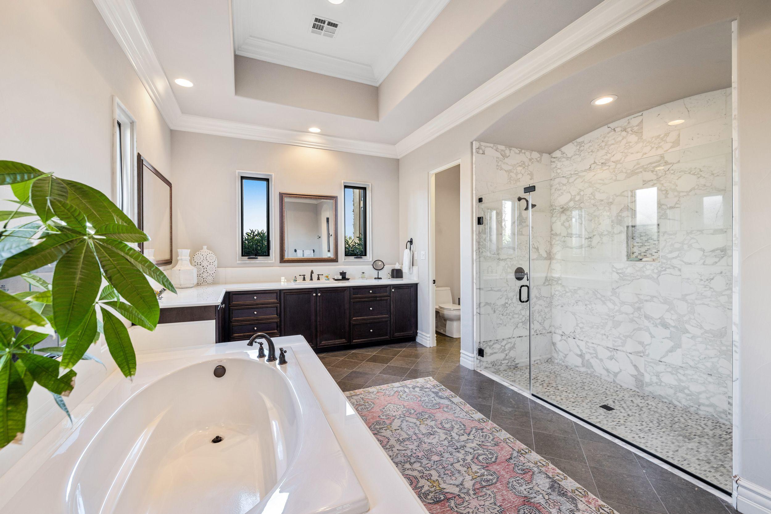 54360 Alysheba Drive La Quinta, CA 92253 - Photo 15 of 24 a en suite spacious bathroom with a double vanity sink a mirror and a shower