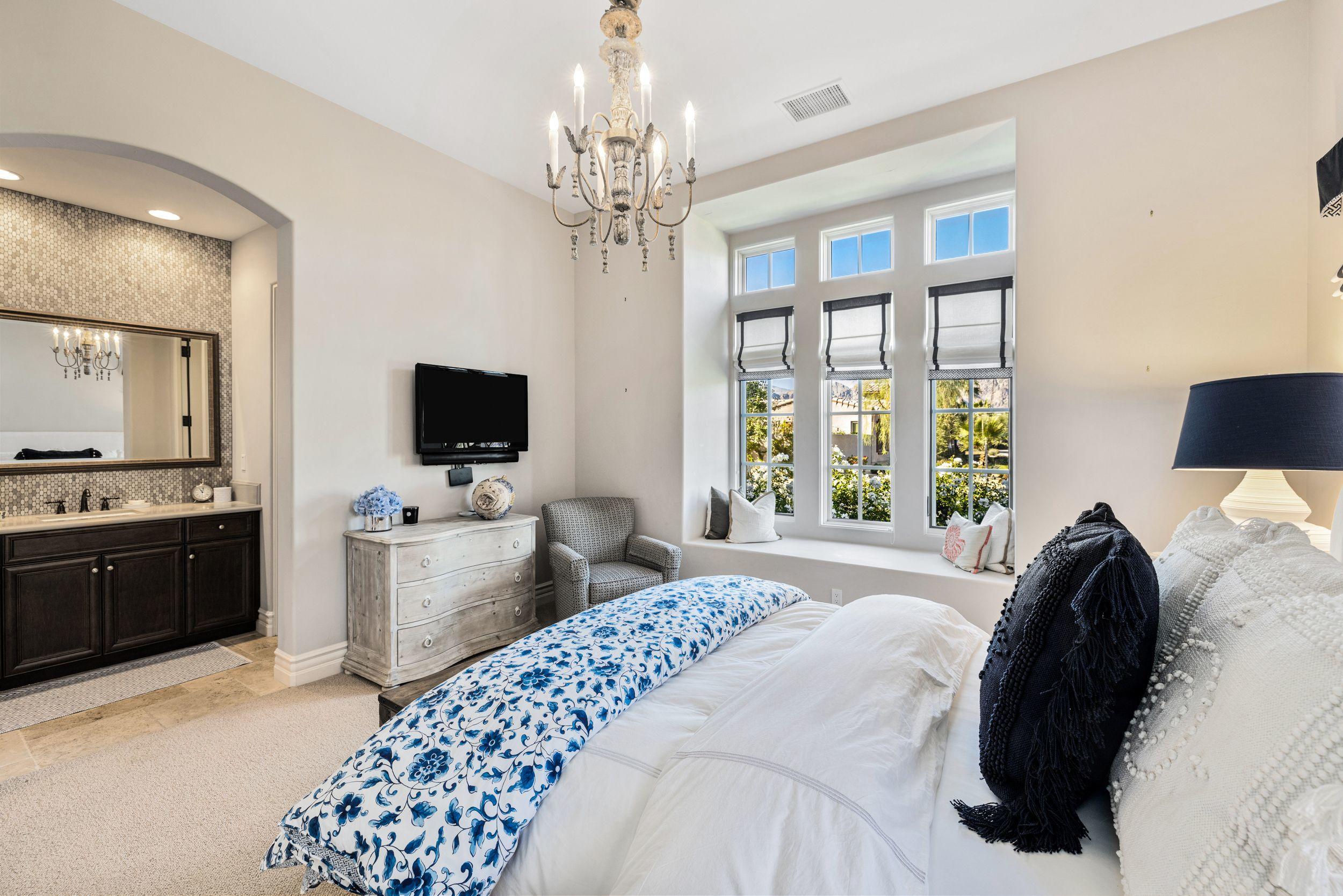 54360 Alysheba Drive La Quinta, CA 92253 - Photo 17 of 24 a bedroom with a large bed and a flat tv screen