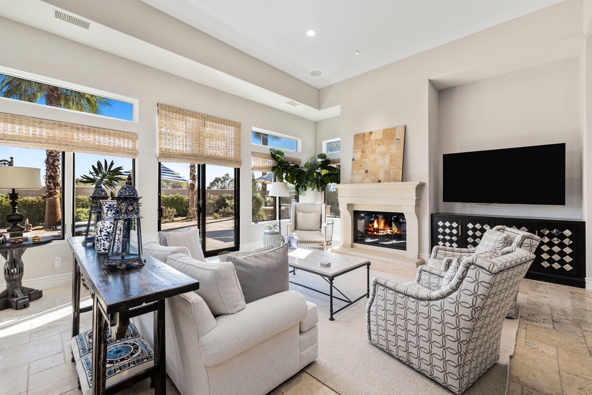 54360 Alysheba Drive La Quinta, CA 92253 - Photo 7 of 24 a living room with furniture a flat screen tv and a fireplace