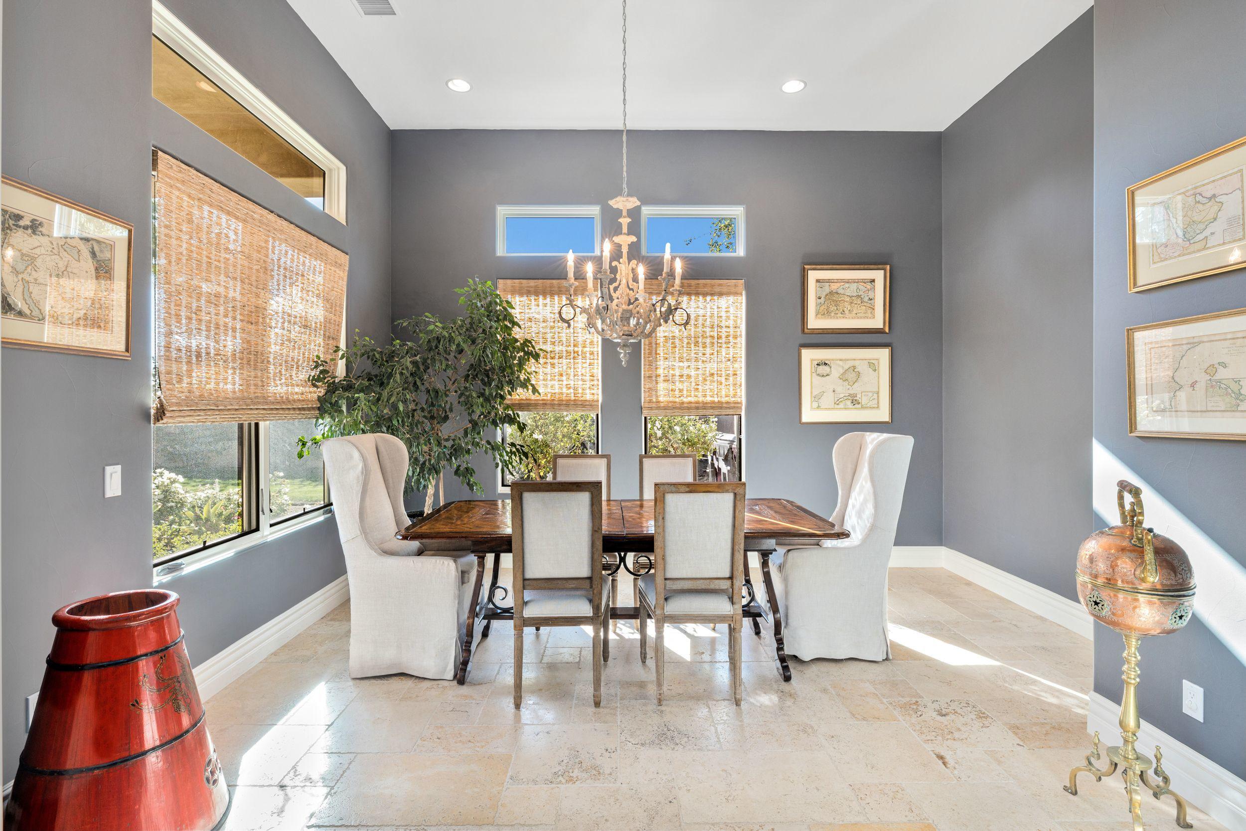 54360 Alysheba Drive La Quinta, CA 92253 - Photo 9 of 24 a view of a dining room with furniture a chandelier and wooden floor