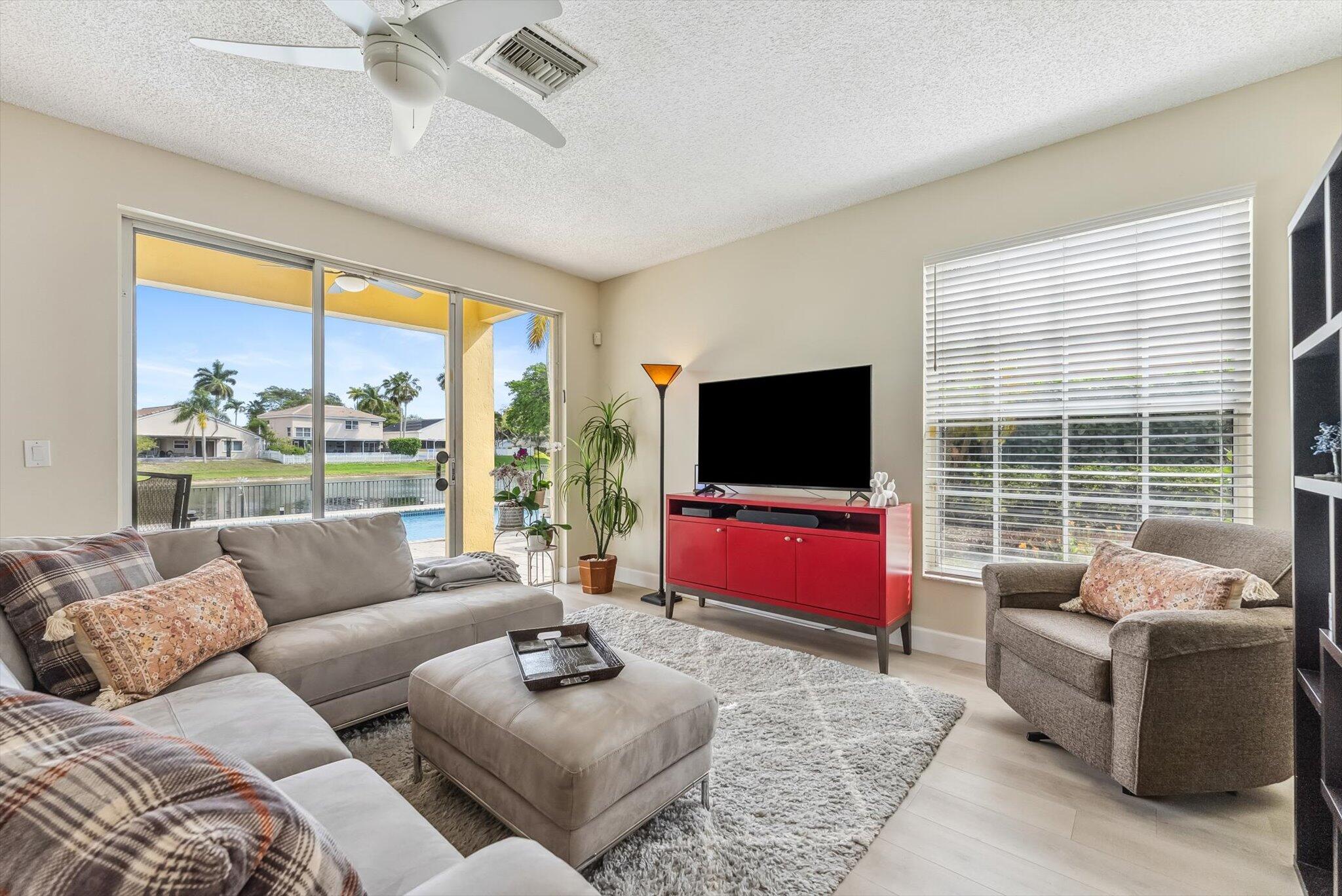 640 Culpepper Terrace Davie, FL 33325 - Photo 11 of 68 a living room with furniture a flat screen tv and a large window