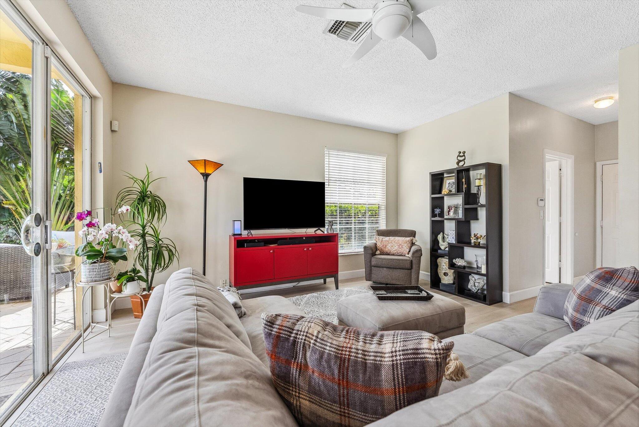 640 Culpepper Terrace Davie, FL 33325 - Photo 12 of 68 a living room with furniture a flat screen tv and a large window