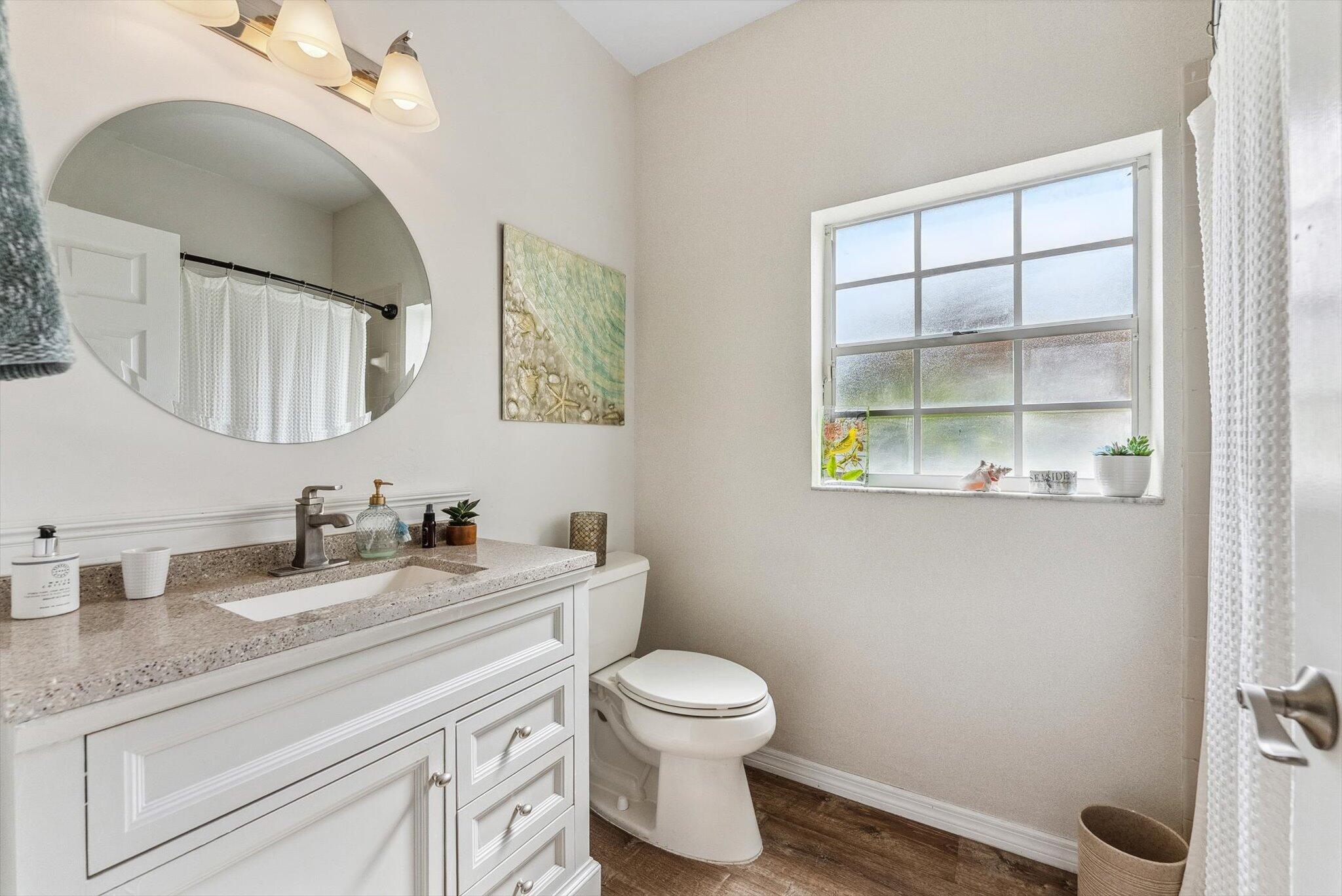 640 Culpepper Terrace Davie, FL 33325 - Photo 14 of 68 a bathroom with a granite countertop toilet sink and mirror