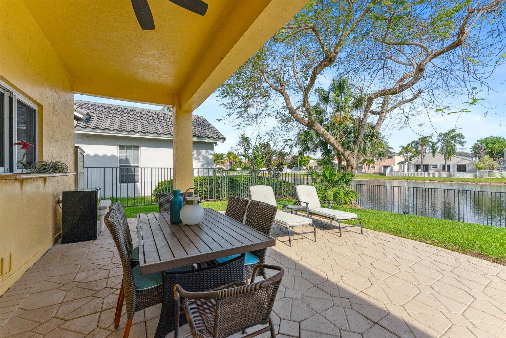 640 Culpepper Terrace Davie, FL 33325 - Photo 23 of 68 a view of backyard with a table and chairs next to a yard