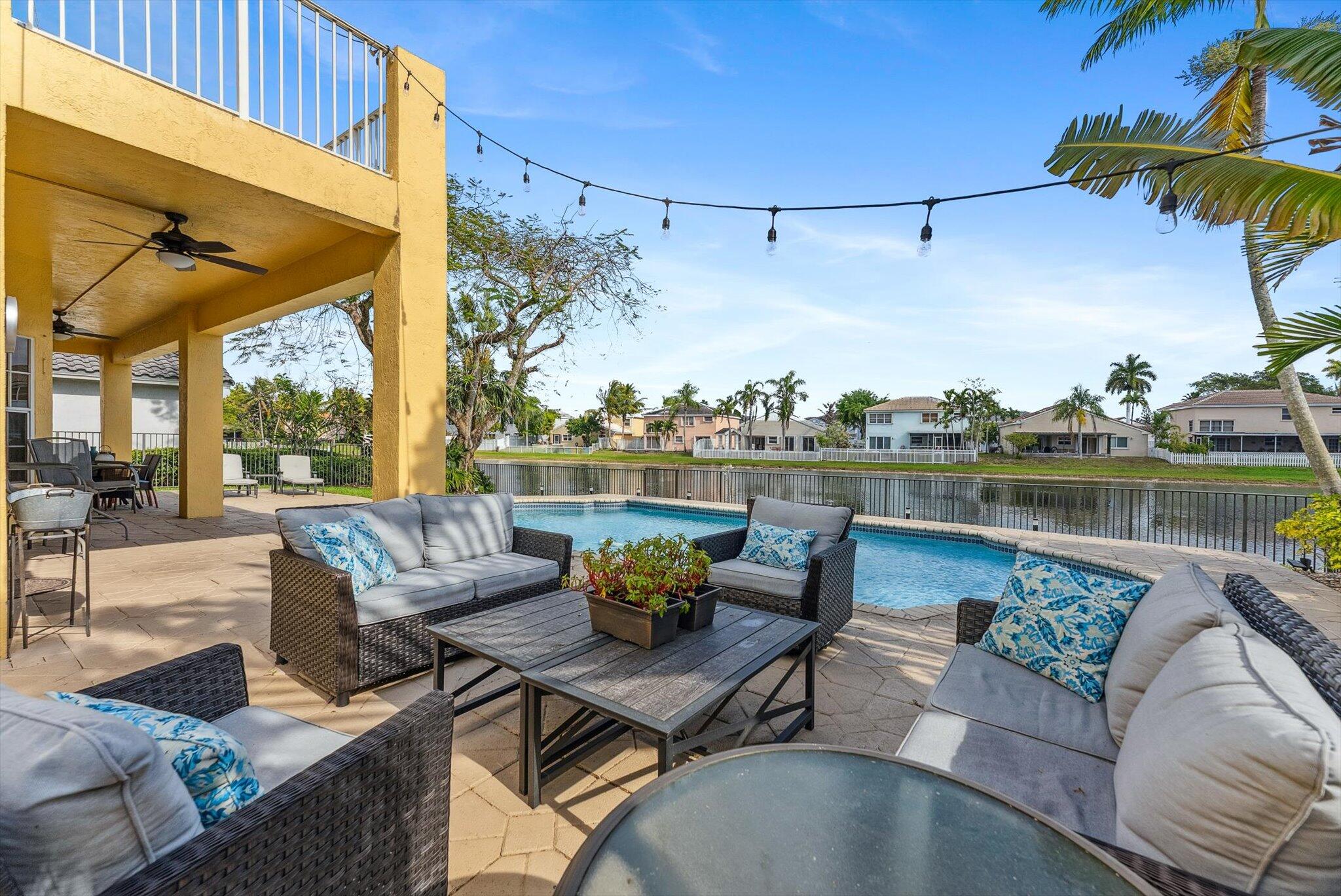 640 Culpepper Terrace Davie, FL 33325 - Photo 27 of 68 a living room with patio furniture and a floor to ceiling window
