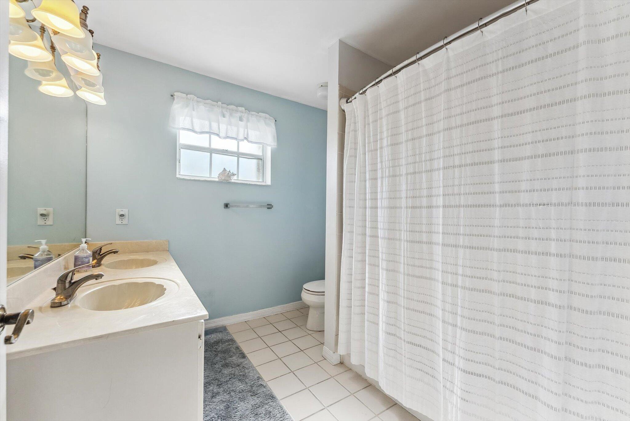 640 Culpepper Terrace Davie, FL 33325 - Photo 48 of 68 a bathroom with a sink a toilet and shower curtain