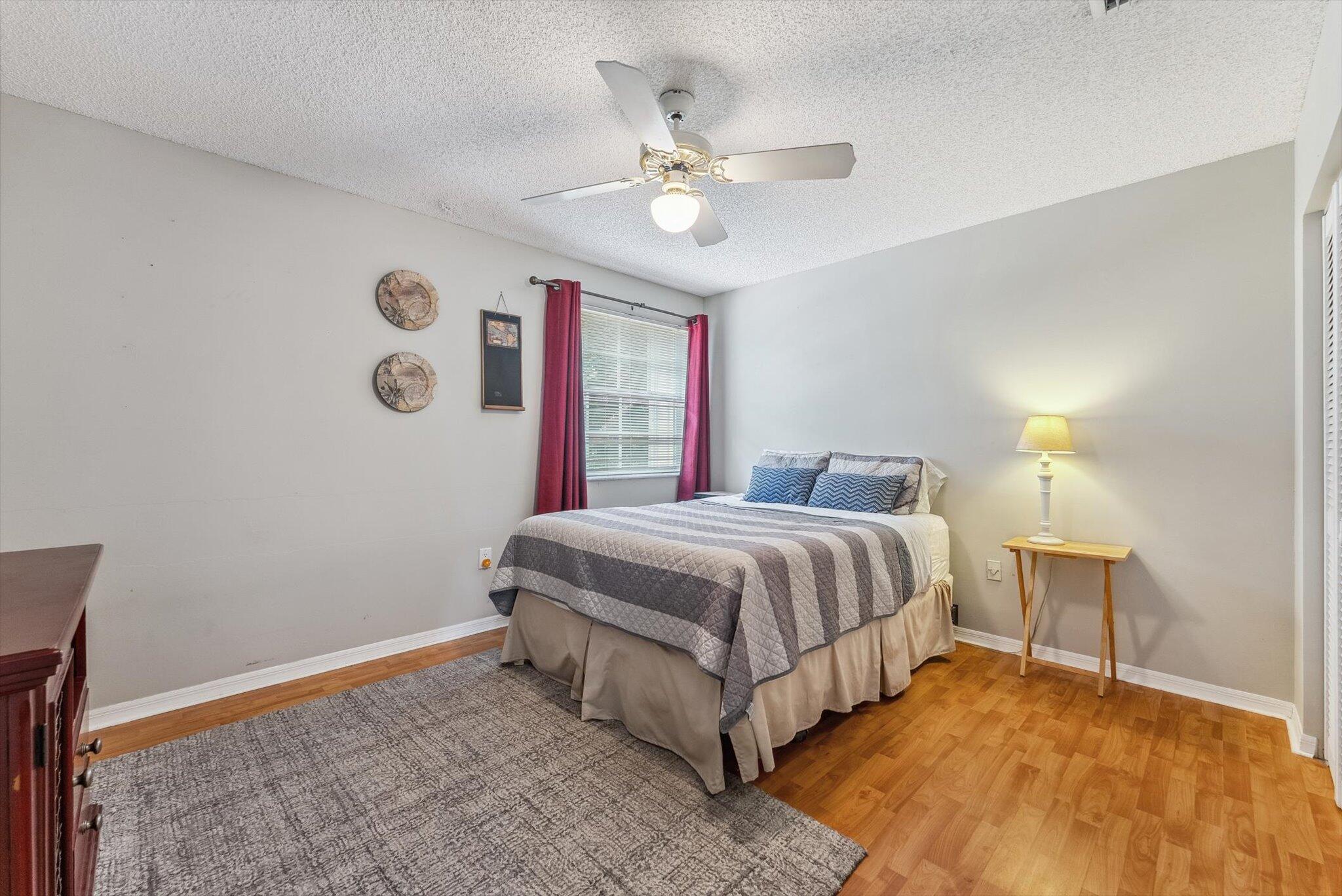 640 Culpepper Terrace Davie, FL 33325 - Photo 49 of 68 a spacious bedroom with a bed and a chandelier