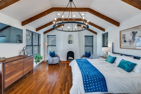 a bedroom with a bed and a chandelier