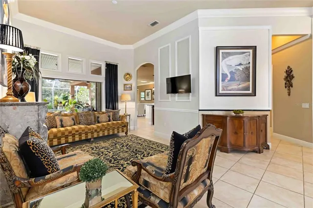 a living room with furniture a chandelier and a window