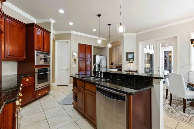 a kitchen with a sink a counter top space stainless steel appliances and a window
