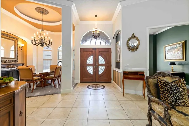 an entryway with a livingroom view and windows