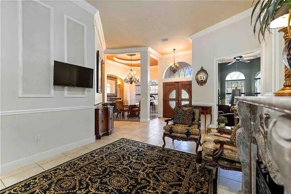 a view of a dining room with furniture and chandelier