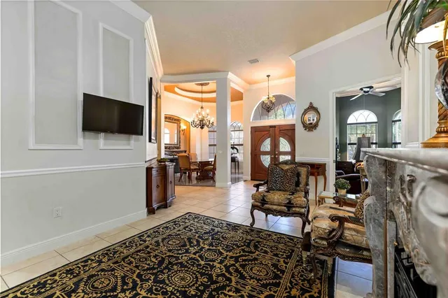 a view of a dining room with furniture and chandelier