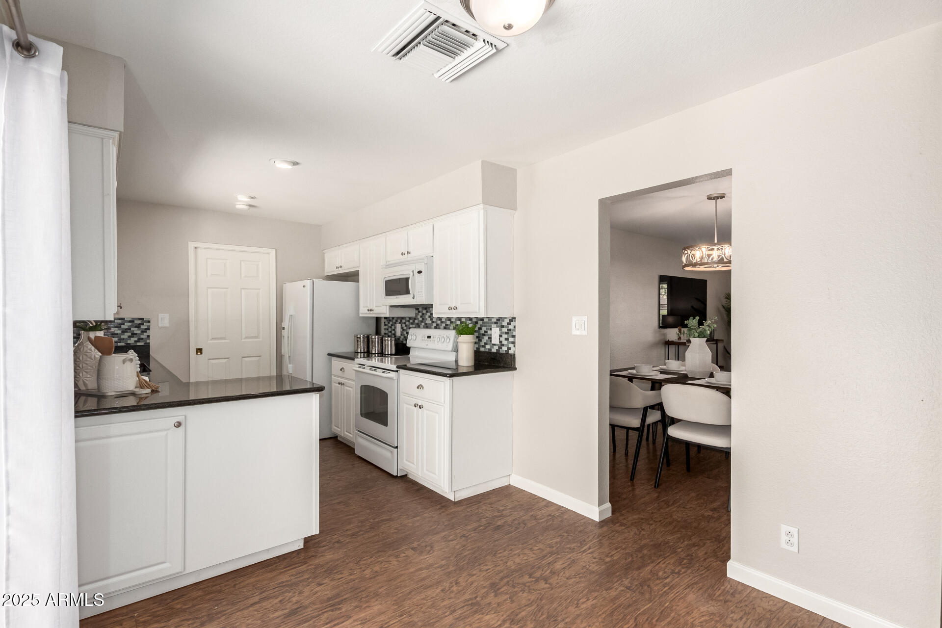 1237 East Gemini Drive Tempe, AZ 85283 - Photo 17 of 51 a kitchen with white cabinets and white appliances