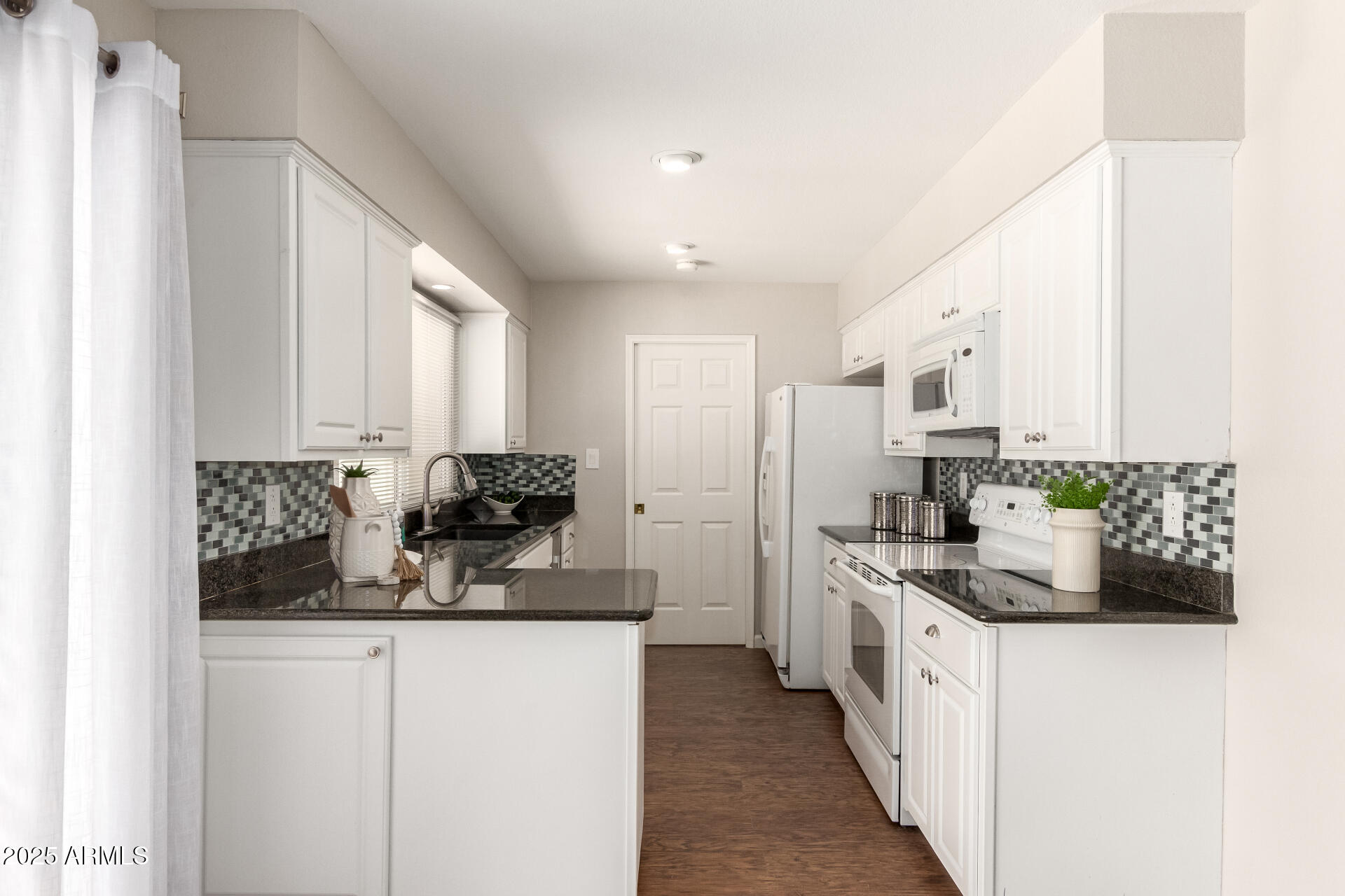 1237 East Gemini Drive Tempe, AZ 85283 - Photo 18 of 51 a kitchen with stainless steel appliances a sink stove and cabinets
