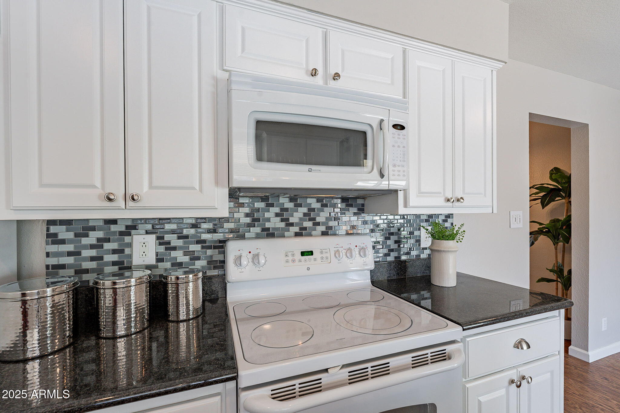 1237 East Gemini Drive Tempe, AZ 85283 - Photo 21 of 51 a kitchen with granite countertop white cabinets and white appliances
