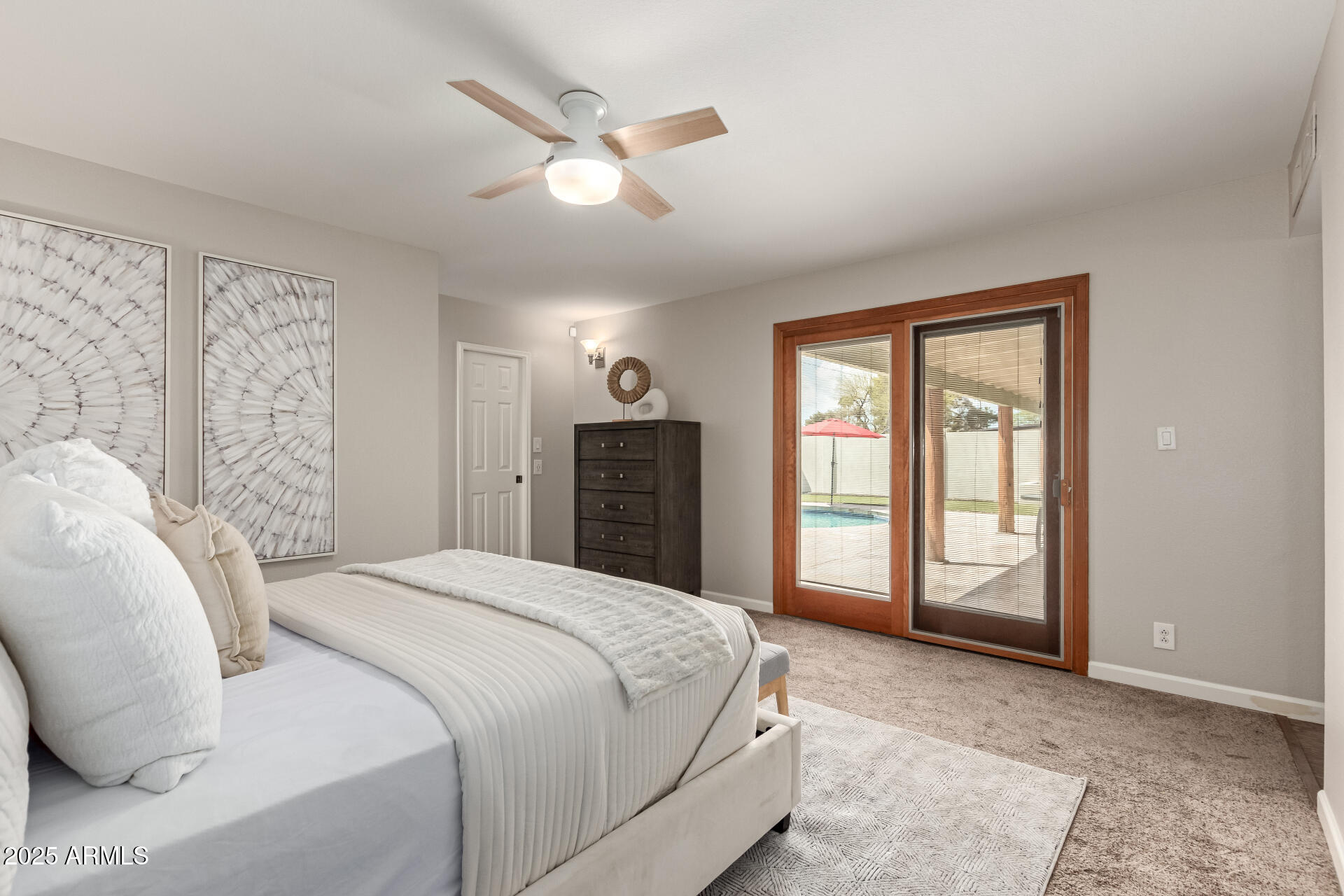 1237 East Gemini Drive Tempe, AZ 85283 - Photo 23 of 51 a spacious bedroom with a large bed and a chandelier