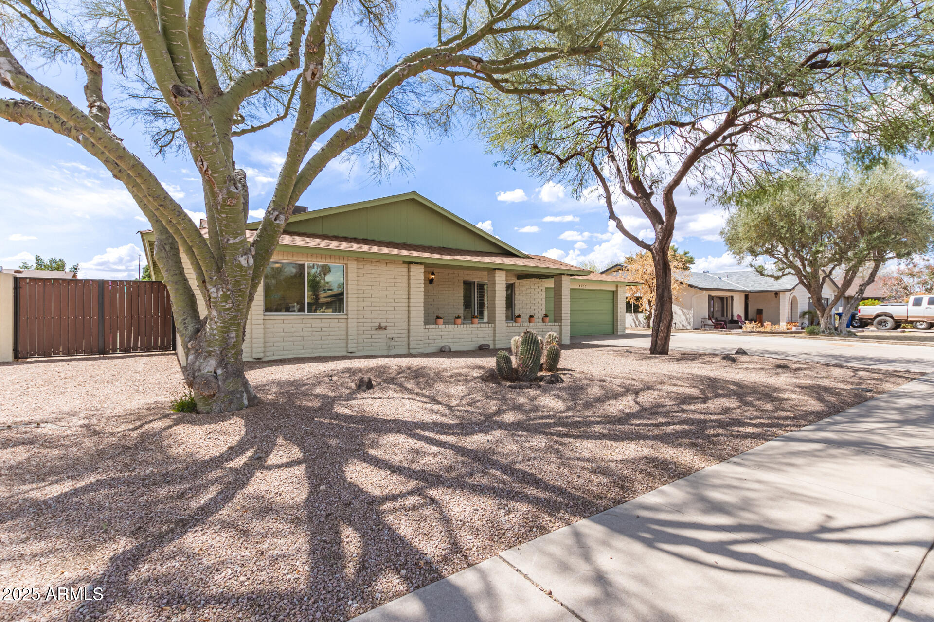 1237 East Gemini Drive Tempe, AZ 85283 - Photo 2 of 51 a tree in front of a white house