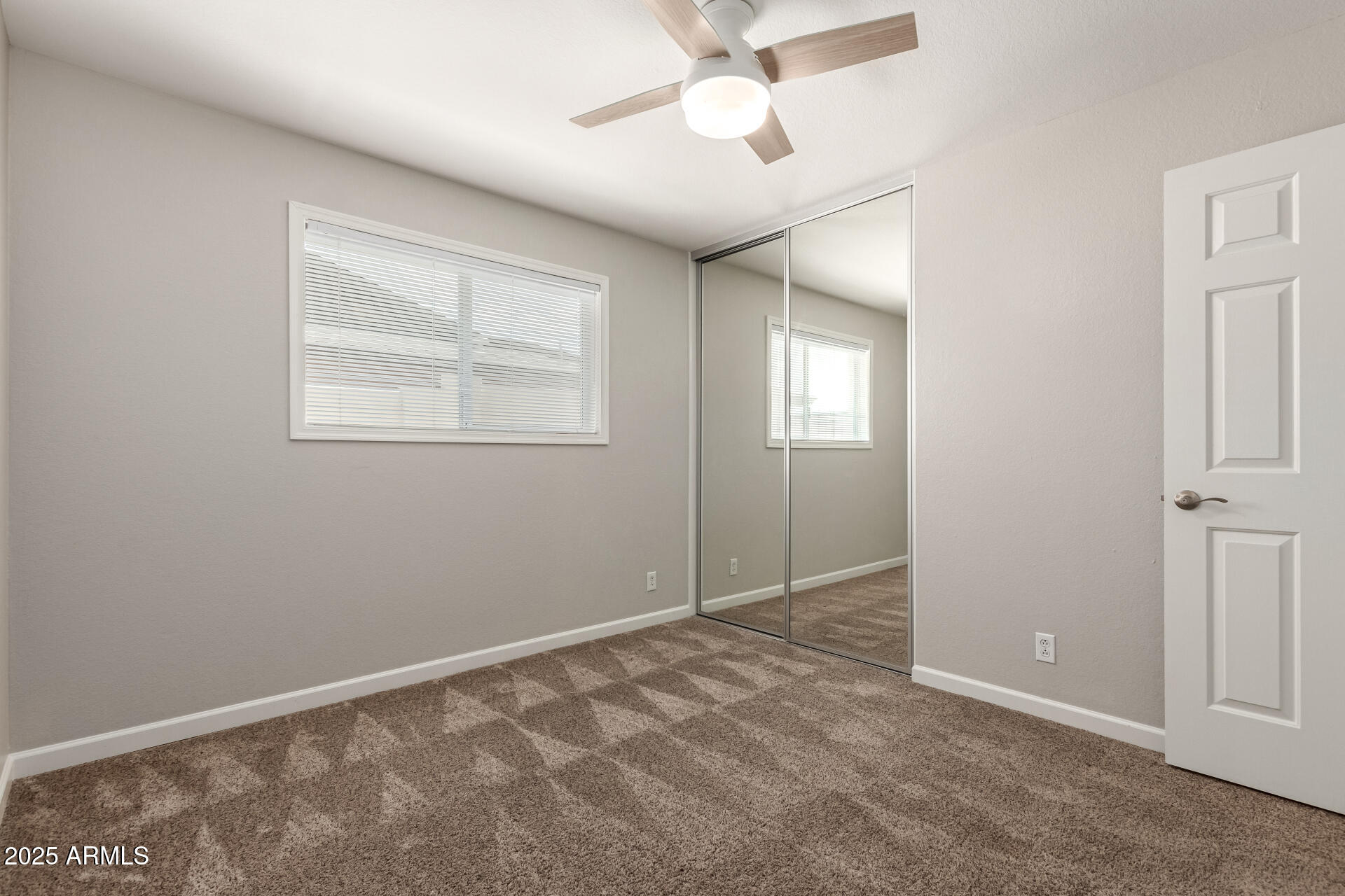 1237 East Gemini Drive Tempe, AZ 85283 - Photo 34 of 51 an empty room with windows and fan