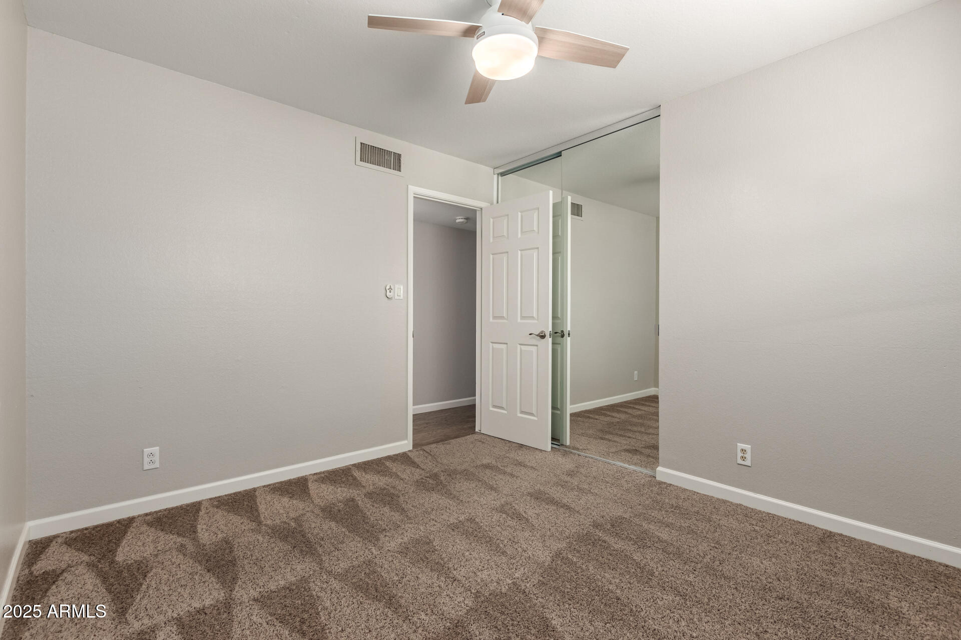 1237 East Gemini Drive Tempe, AZ 85283 - Photo 36 of 51 an empty room with a ceiling fan and a window