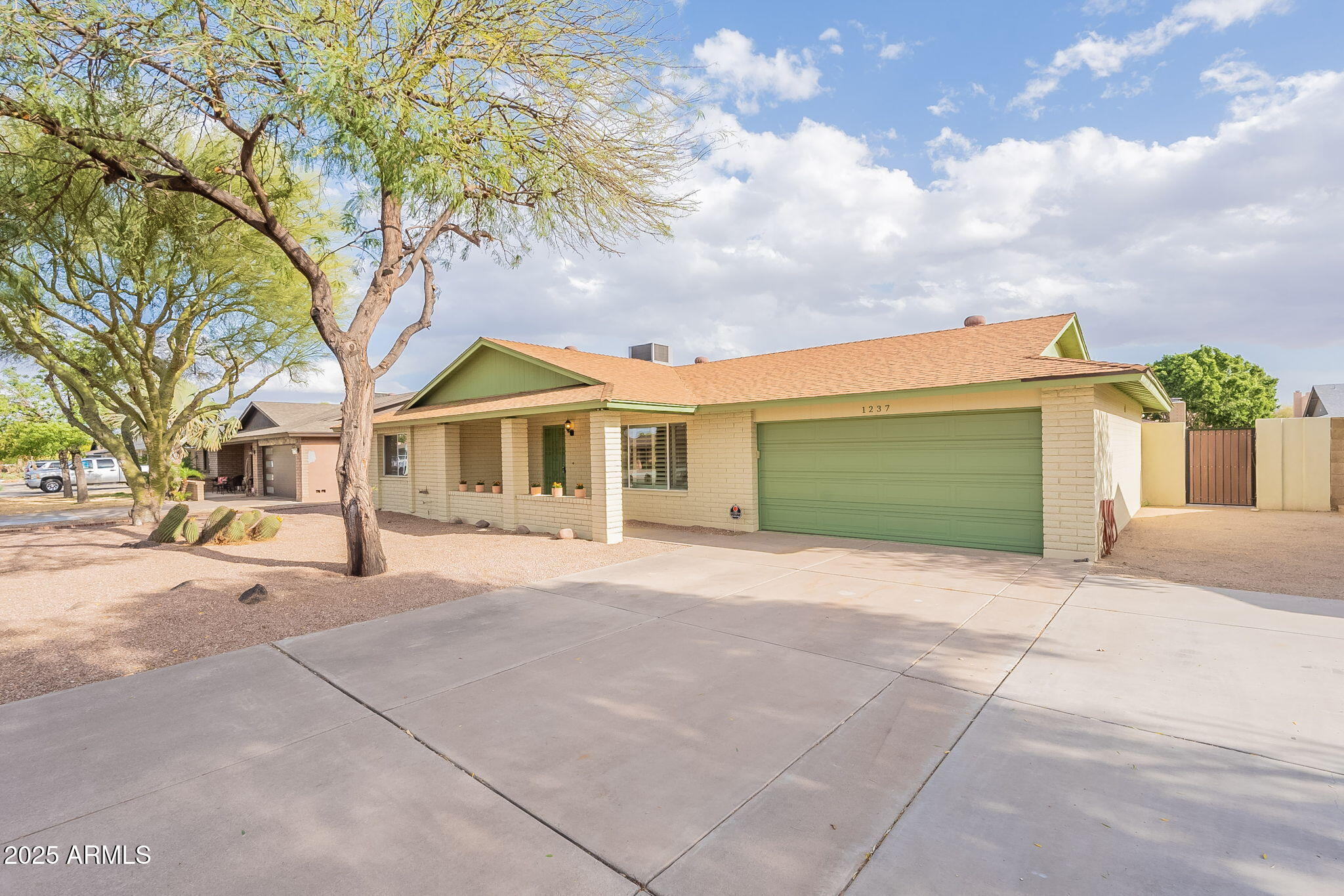 1237 East Gemini Drive Tempe, AZ 85283 - Photo 4 of 51 a front view of a house with a yard and garage