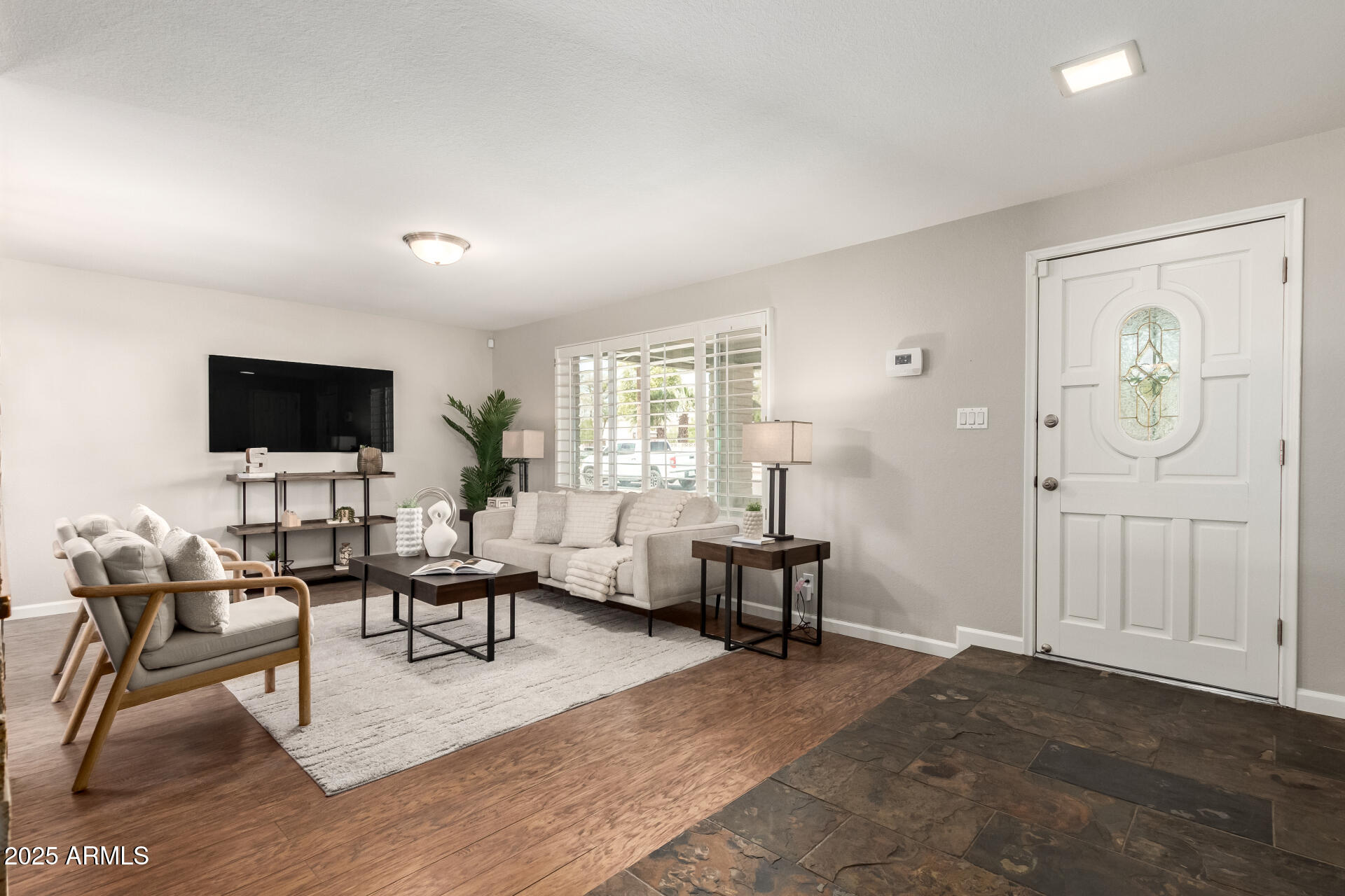 1237 East Gemini Drive Tempe, AZ 85283 - Photo 6 of 51 a living room with furniture and a flat screen tv