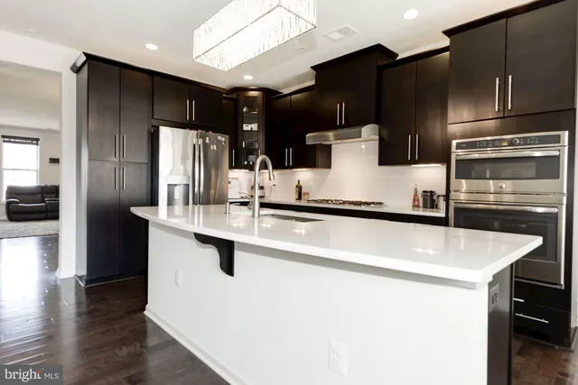 a kitchen with stainless steel appliances a refrigerator and a sink