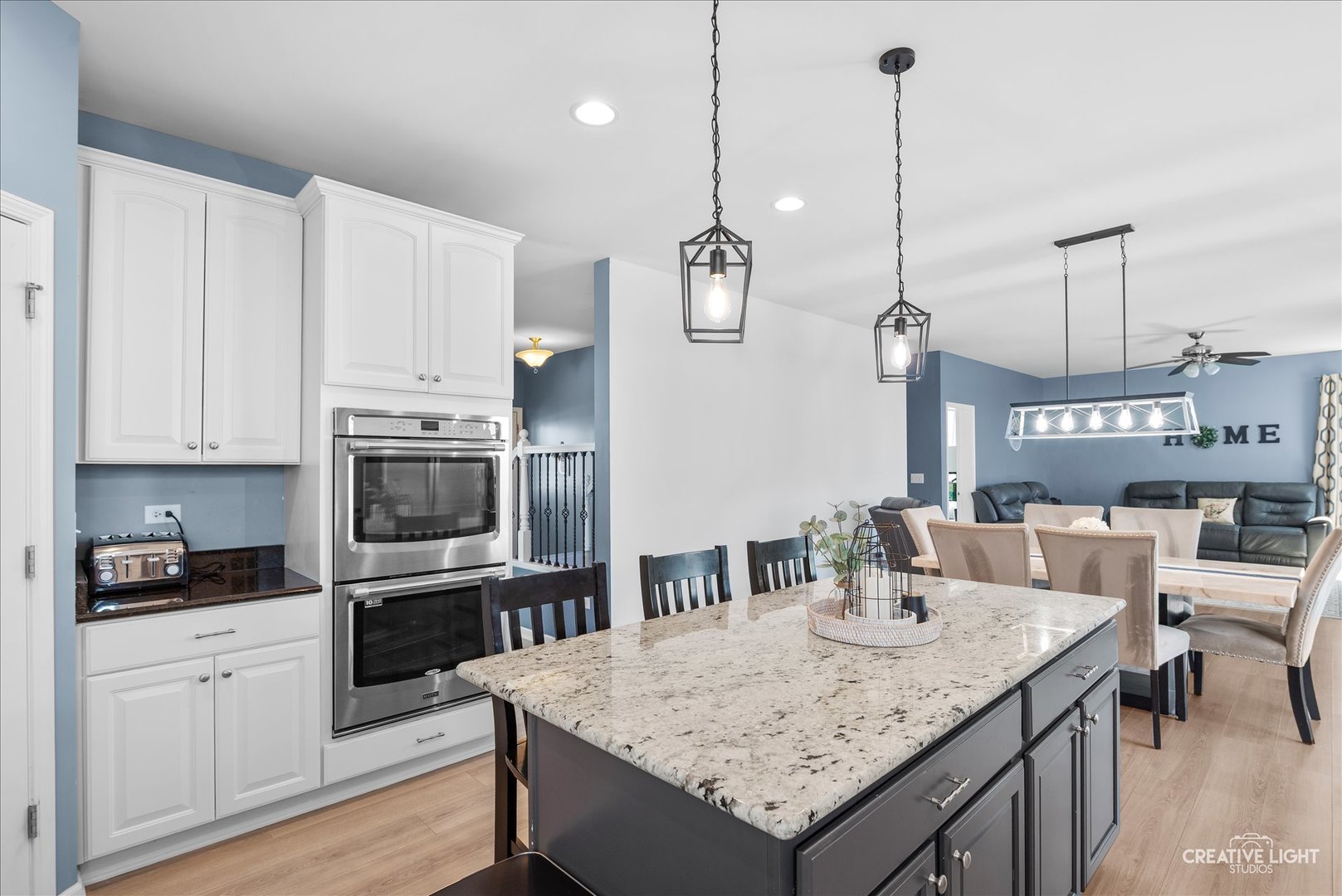 1615 Seward Road Joliet, IL 60431 - Photo 13 of 31 a kitchen with stainless steel appliances granite countertop a sink a stove a microwave oven a refrigerator with white cabinets and wooden floor