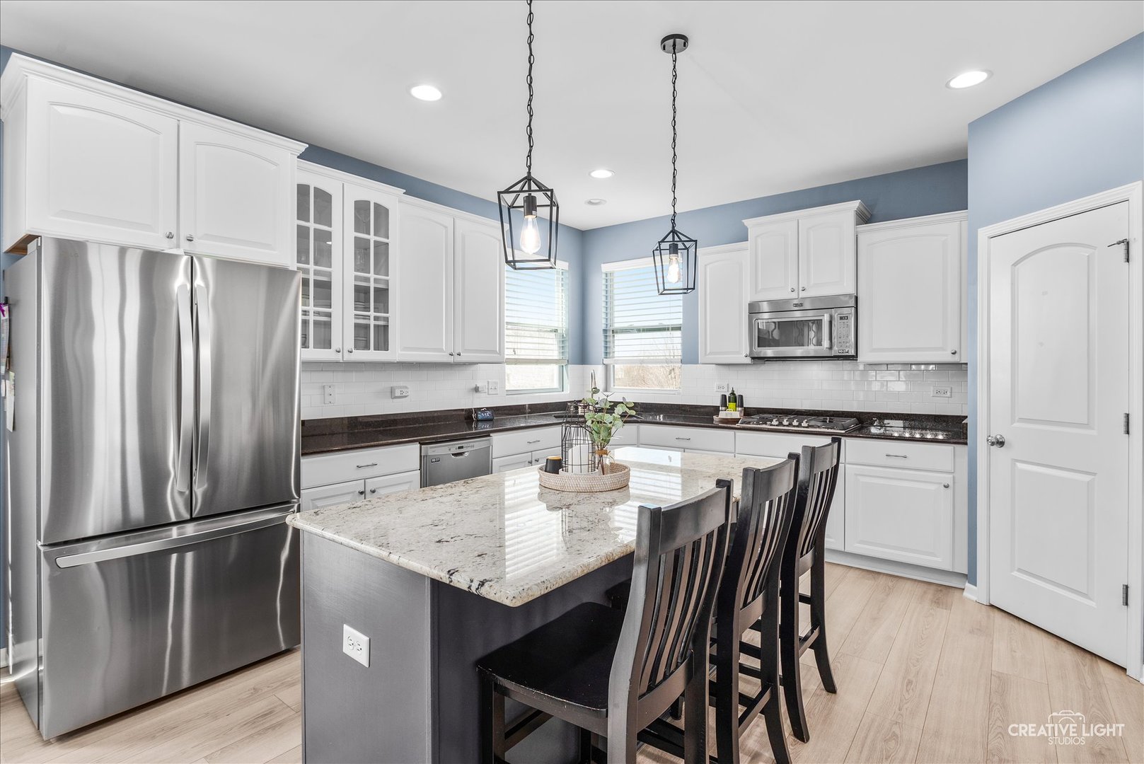 1615 Seward Road Joliet, IL 60431 - Photo 3 of 31 a kitchen with stainless steel appliances granite countertop a refrigerator a sink a stove a dining table and chairs