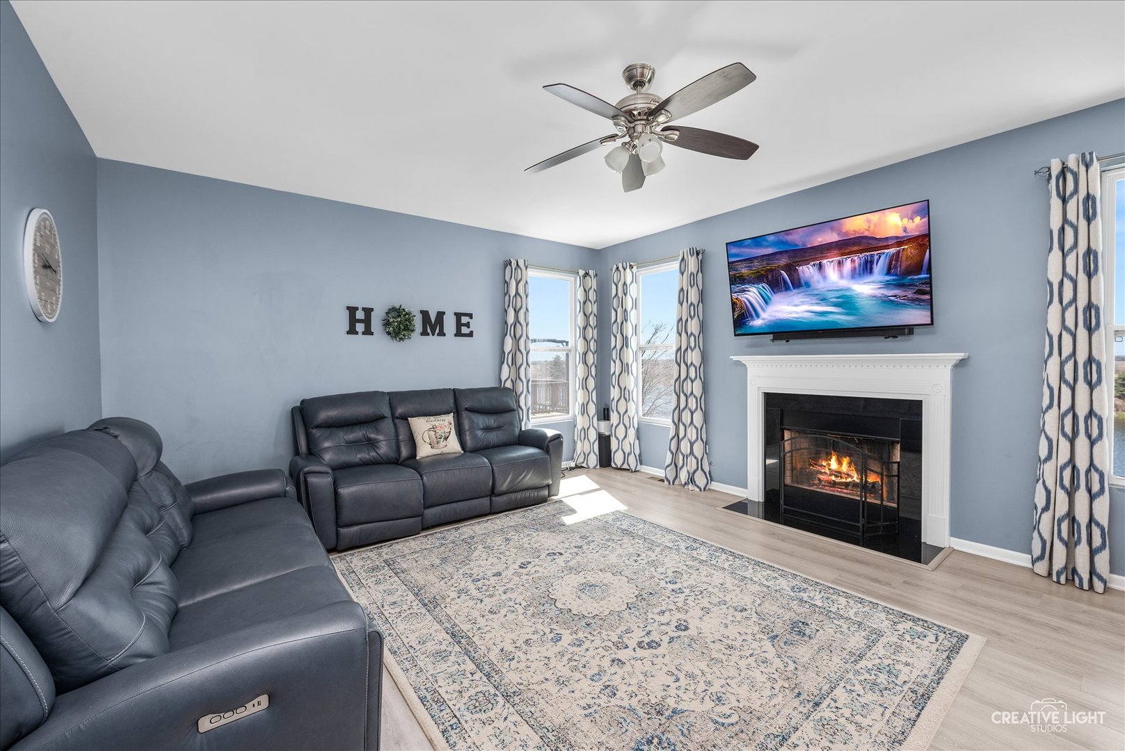 1615 Seward Road Joliet, IL 60431 - Photo 4 of 31 a living room with furniture a flat screen tv and a fireplace