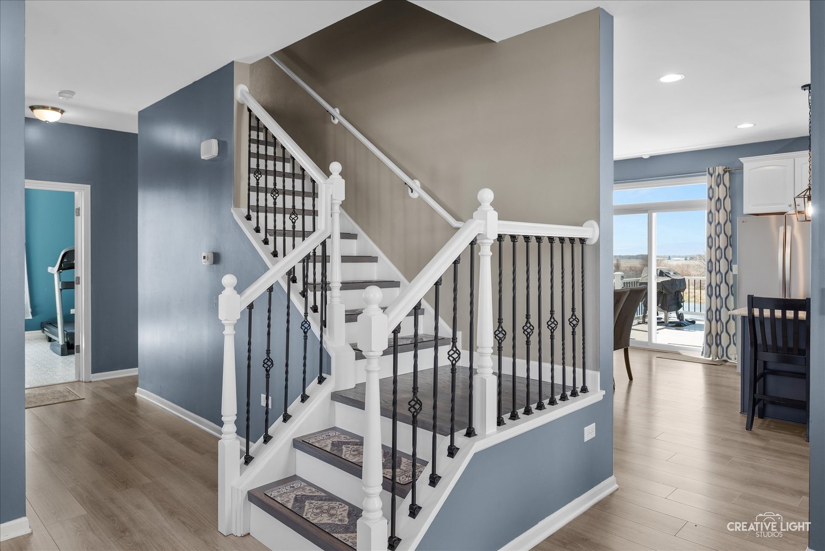 1615 Seward Road Joliet, IL 60431 - Photo 7 of 31 a view of staircase with lots of frames on wall and a dining table