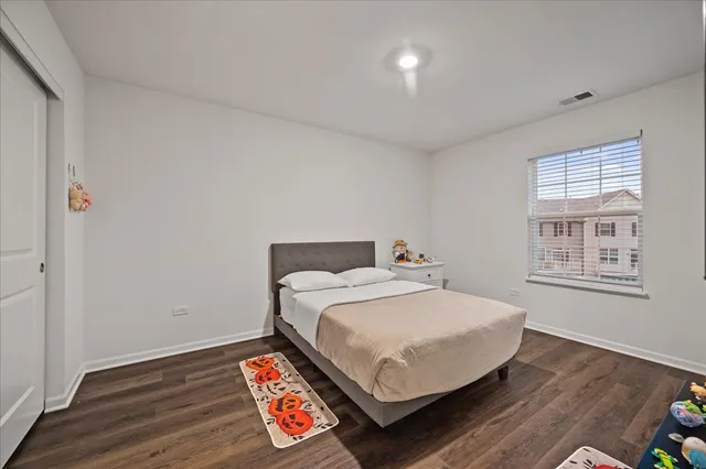 a bed sitting in a bedroom next to a window