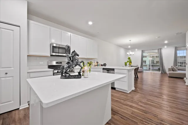 a kitchen with a sink a counter top space appliances and cabinets