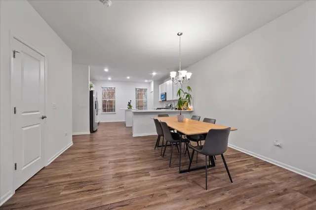 a view of a dining room with furniture and wooden floor
