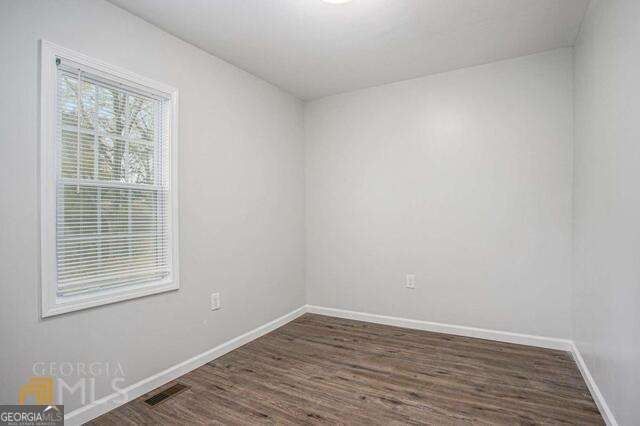 6236 Front Street Douglasville, GA 30134 - Photo 14 of 30 an empty room with wooden floor and windows