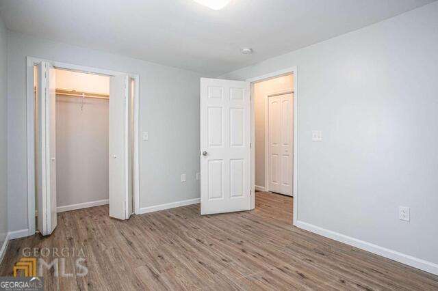 6236 Front Street Douglasville, GA 30134 - Photo 20 of 30 an empty room with wooden floor and closet