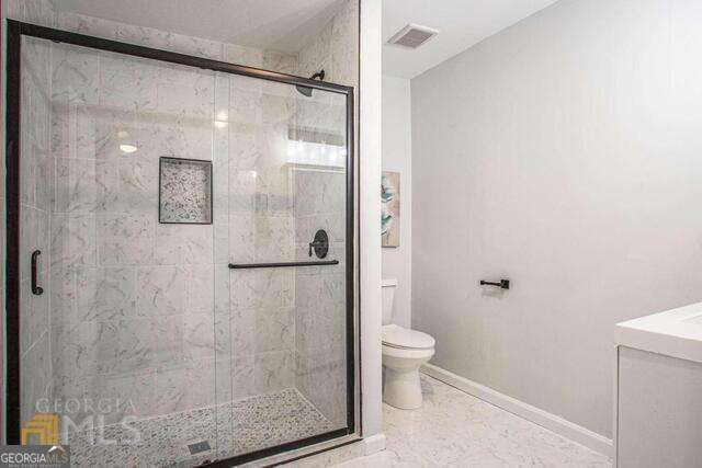 6236 Front Street Douglasville, GA 30134 - Photo 21 of 30 a bathroom with a shower and toilet