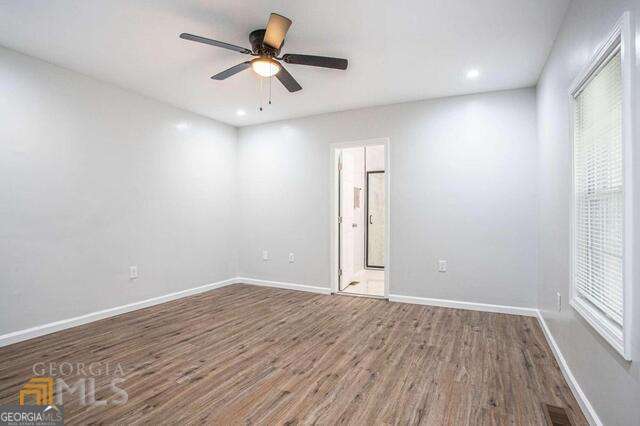 6236 Front Street Douglasville, GA 30134 - Photo 23 of 30 an empty room with wooden floor and windows