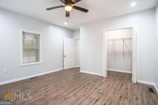 6236 Front Street Douglasville, GA 30134 - Photo 26 of 30 an empty room with wooden floor fan and windows