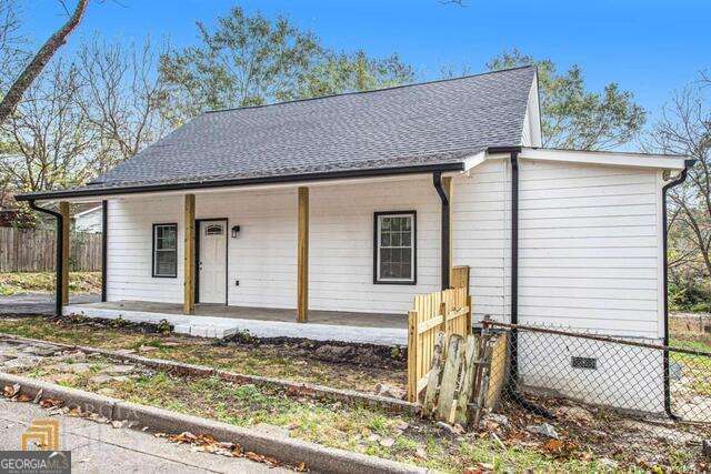 6236 Front Street Douglasville, GA 30134 - Photo 3 of 30 a front view of a house with garden