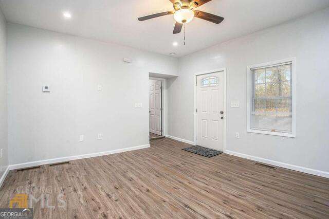 6236 Front Street Douglasville, GA 30134 - Photo 6 of 30 wooden floor in an empty room with a window
