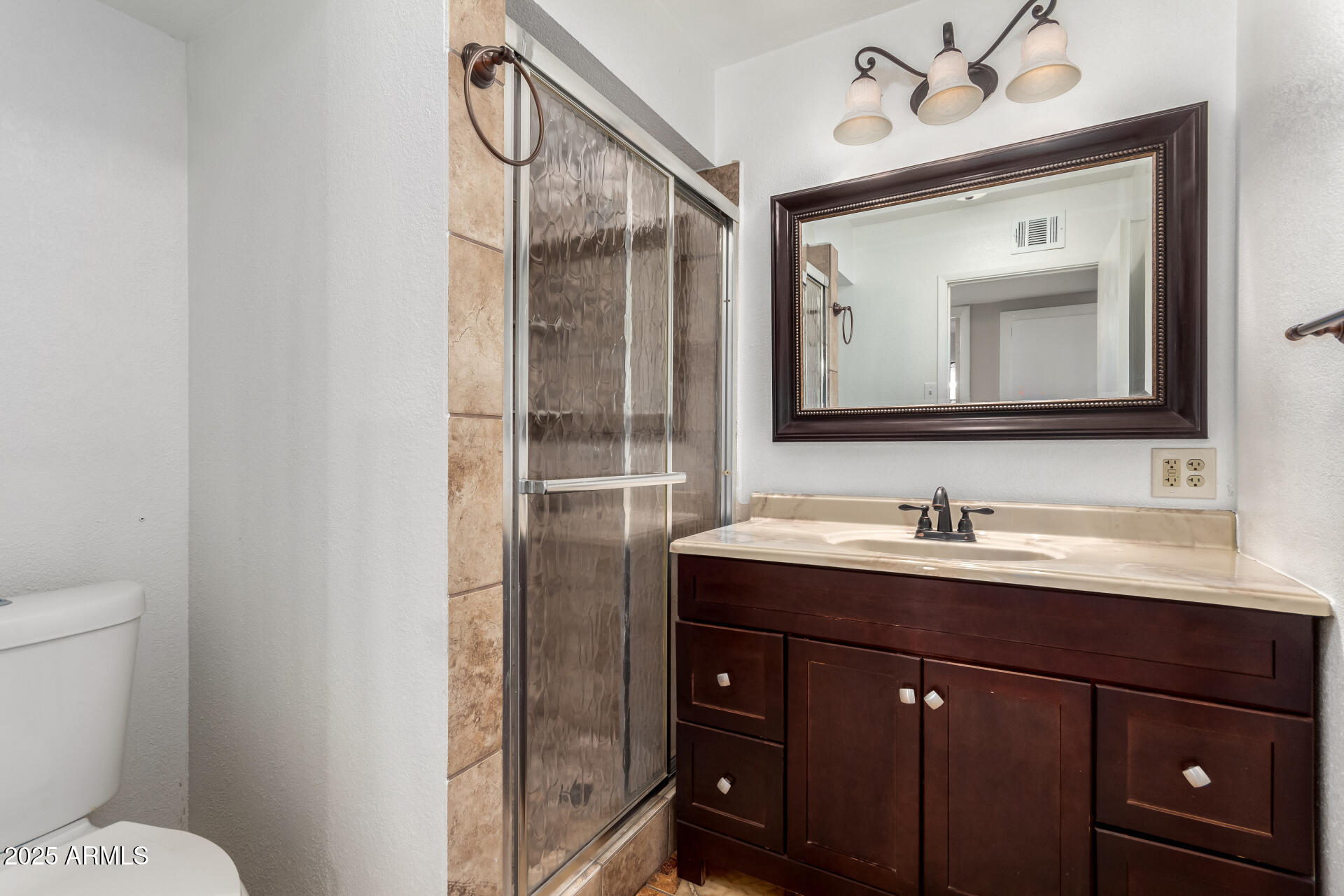 6837 West Camelback Road Phoenix, AZ 85033 - Photo 16 of 24 a bathroom with a toilet sink and mirror