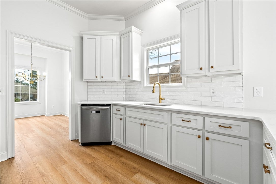 1756 Vfw Road Auburn, AL 36830 - Photo 6 of 26 The kitchen features new cabinetry, quartz counters, & a tile backsplash.