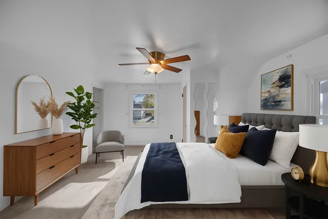 a bedroom with bed and a chandelier