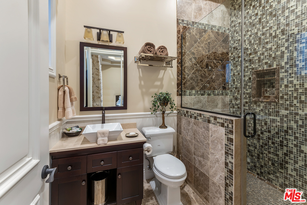 15506 Meadowgate Road Encino, CA 91436 - Photo 34 of 50 a bathroom with a sink and a mirror