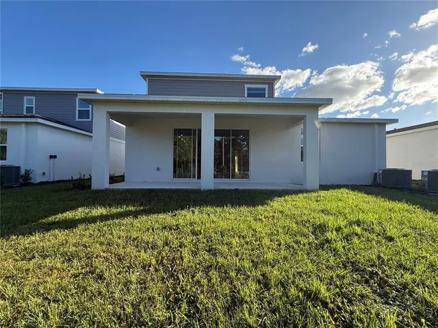 a view of a house with a backyard