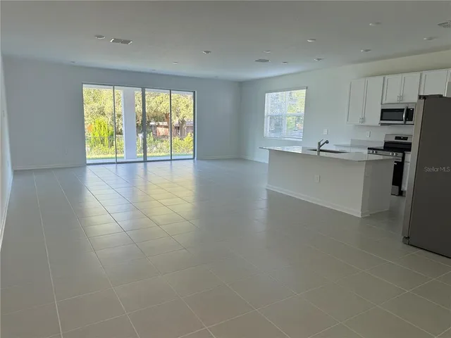 a kitchen with stainless steel appliances a refrigerator sink and cabinets