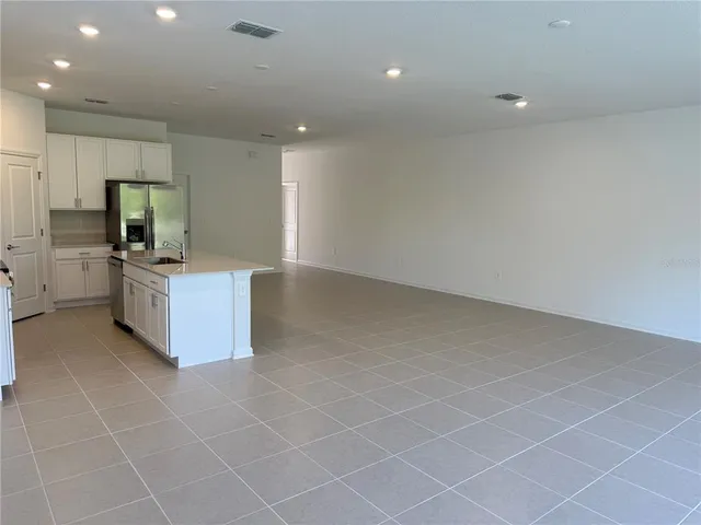 a kitchen with a sink a counter top space stainless steel appliances and cabinets