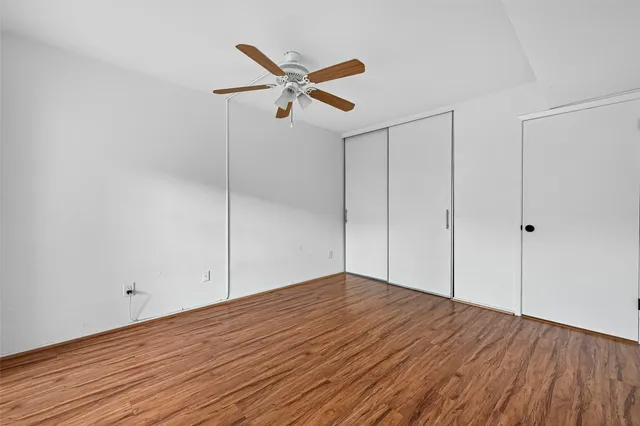 a view of kitchen with wooden floor and electronic appliances